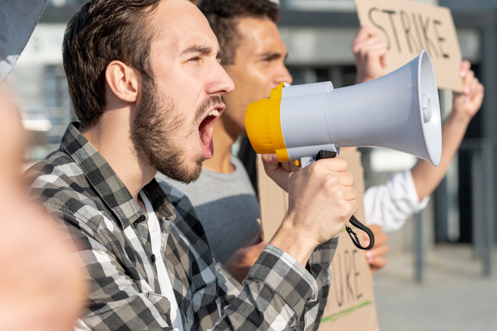 men-demonstrating-together-with-megaphone (1)